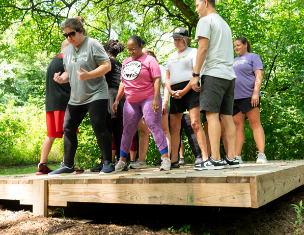 a group of people standing on a wooden platform