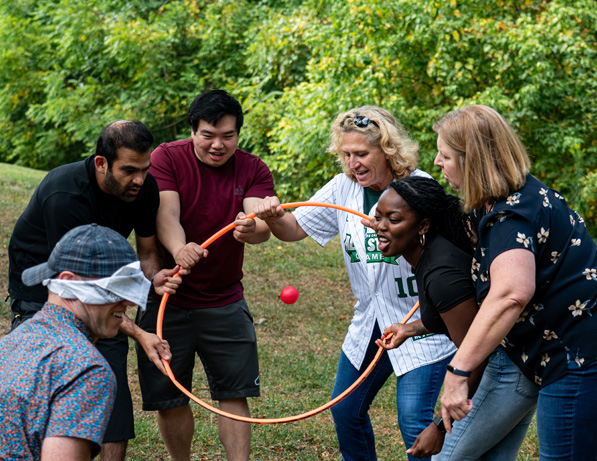 a group of people playing with a hoop