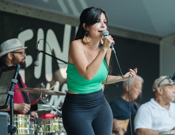 a woman singing into a microphone