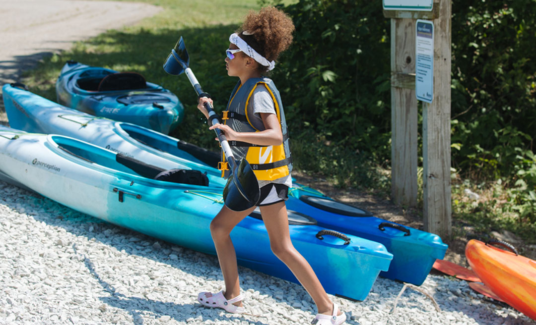a girl holding a paddle