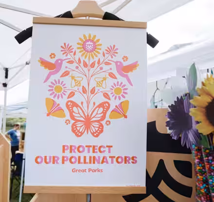 a sign with flowers and birds on it