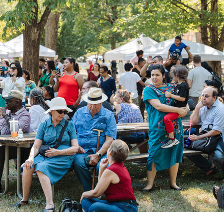 a group of people sitting on picnic tables