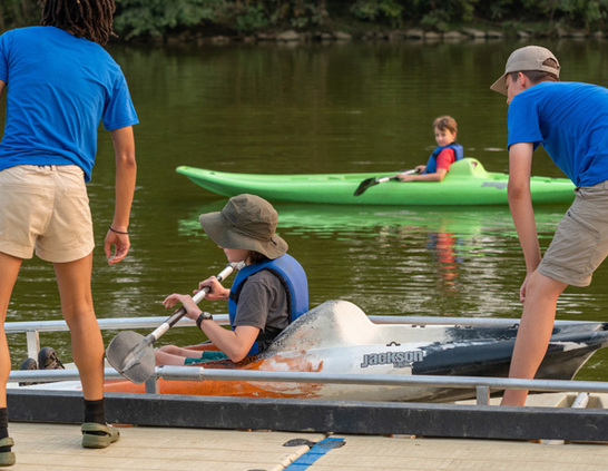 a group of people in kayaks on a lake