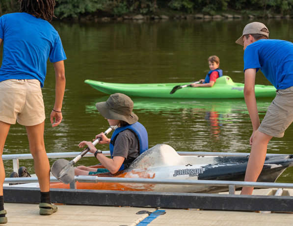 a group of people in kayaks on a lake