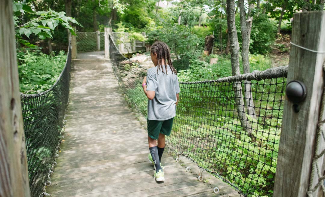 a child walking on a bridge