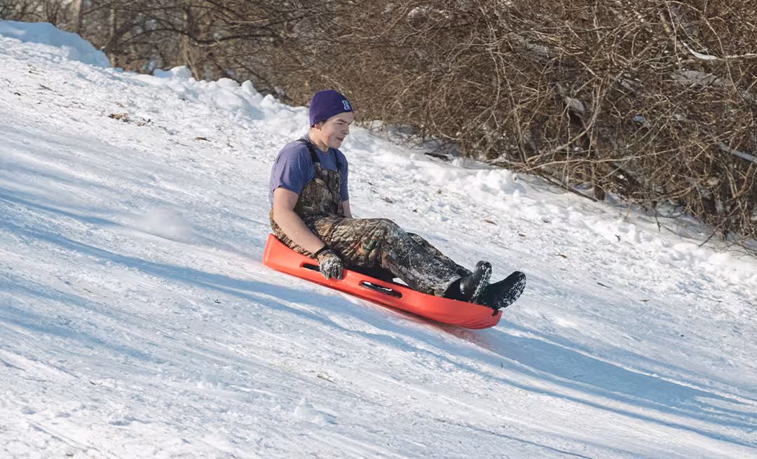 a man sledding down a hill