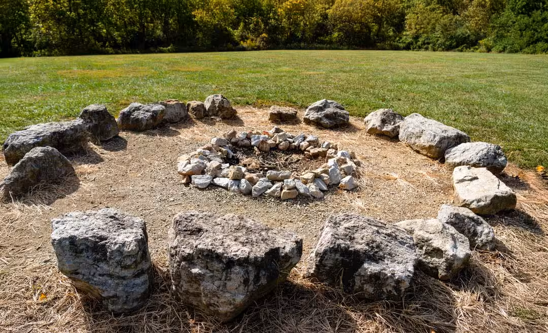 a circular fire pit surrounded by rocks