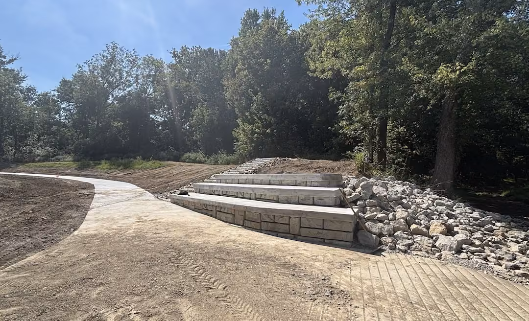 a stone stairs next to a pile of rocks