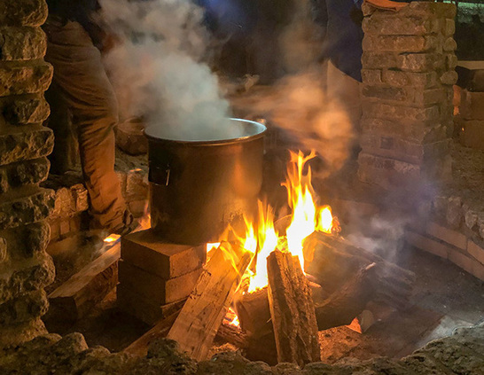 Bonfire with a kettle boiling maple sugar sap
