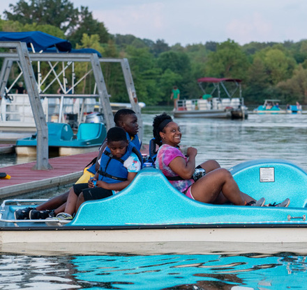 a group of people on a pedal boat