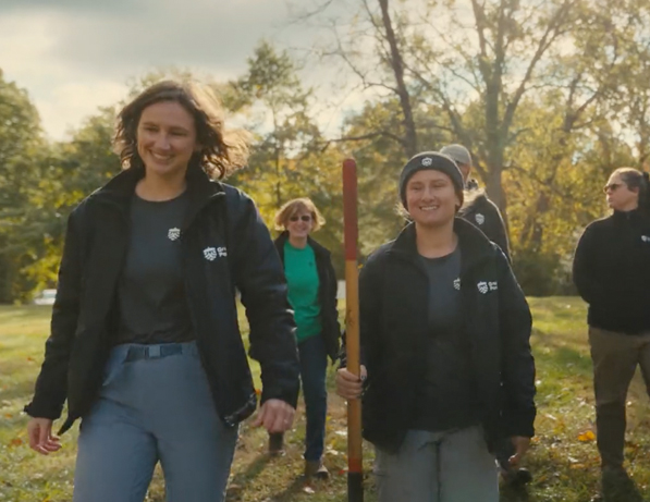 a group of people walking in a field