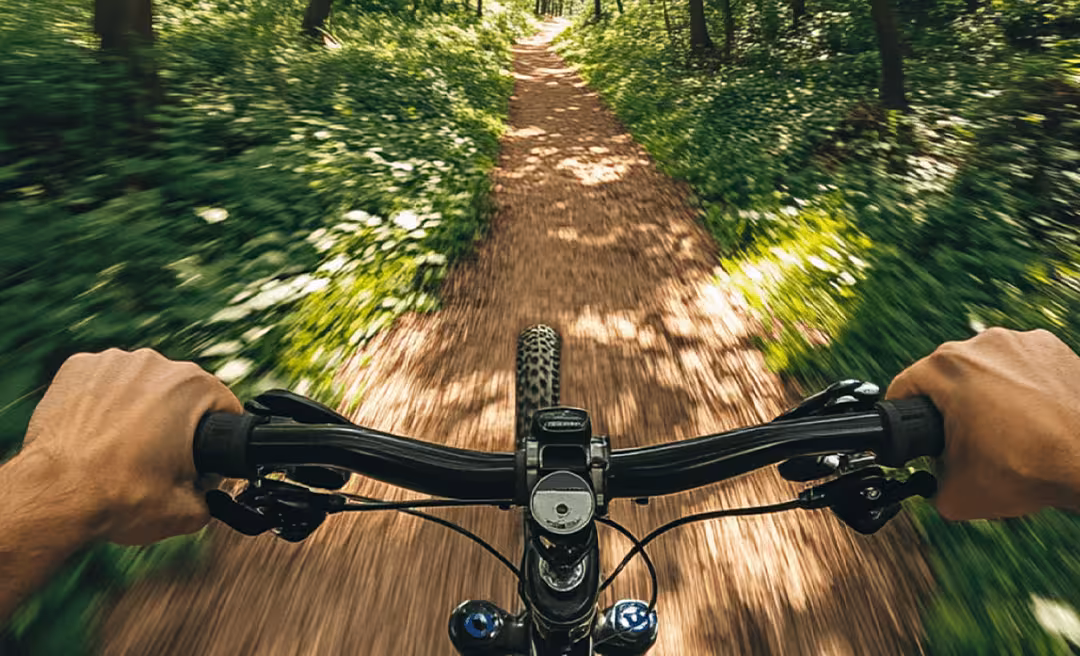 a person riding a bike on a dirt road