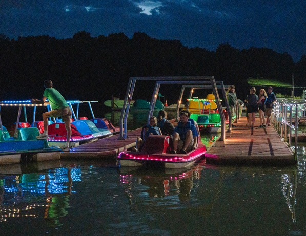 people on a dock with boats and people on it