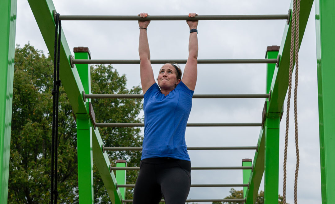 a woman on a monkey bars