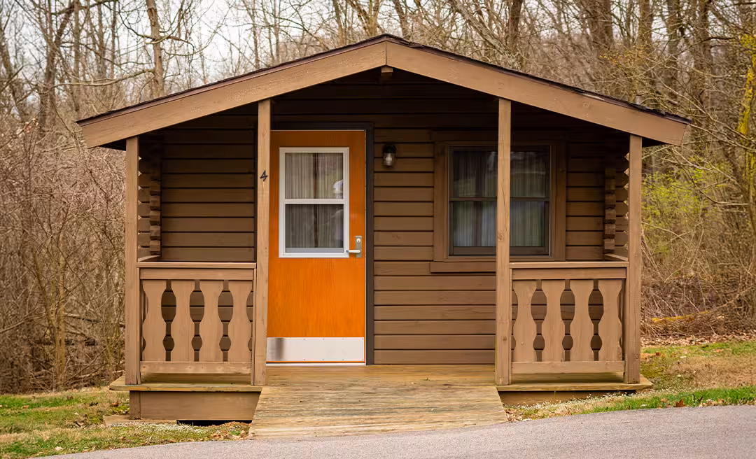 a small cabin with a porch and a door