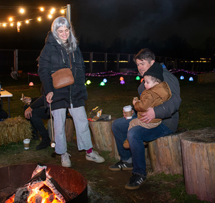a group of people sitting around a fire